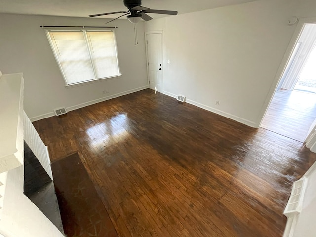 empty room with ceiling fan and dark hardwood / wood-style floors