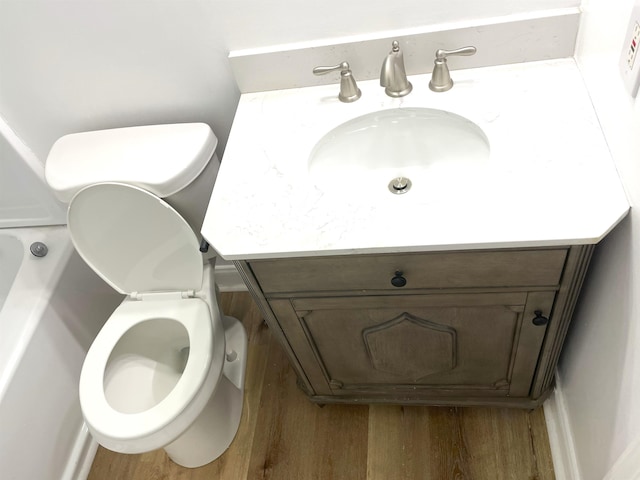 bathroom featuring vanity, toilet, and hardwood / wood-style flooring