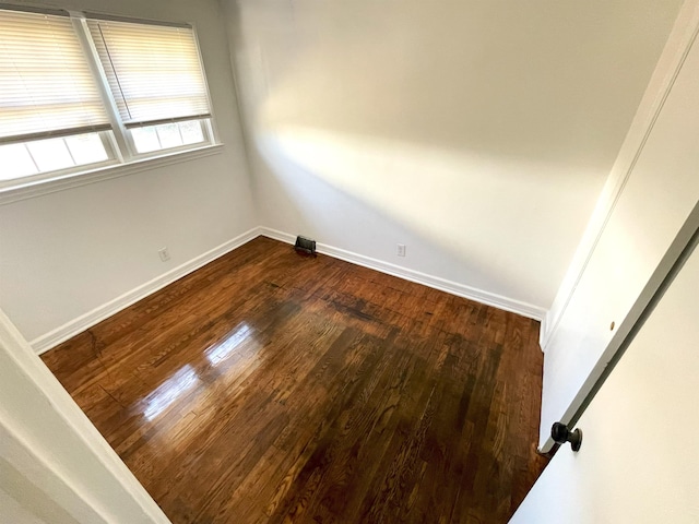 spare room with dark hardwood / wood-style flooring