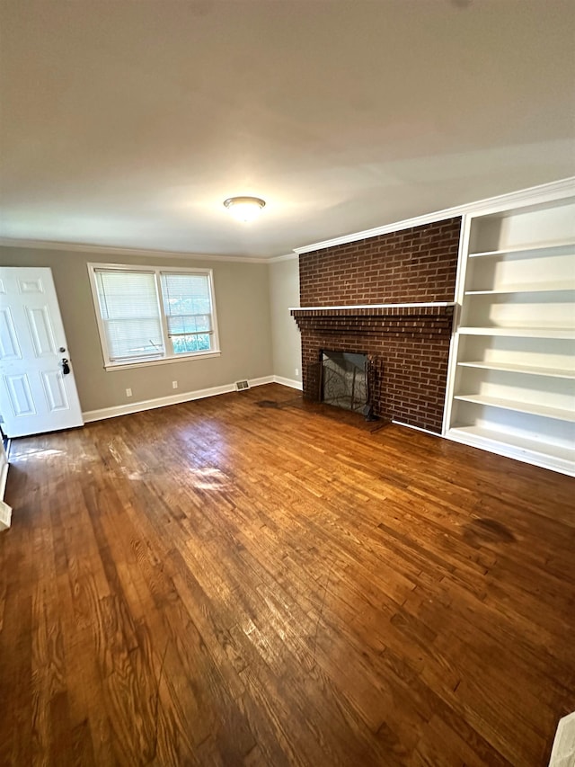 unfurnished living room with hardwood / wood-style flooring, crown molding, and a fireplace