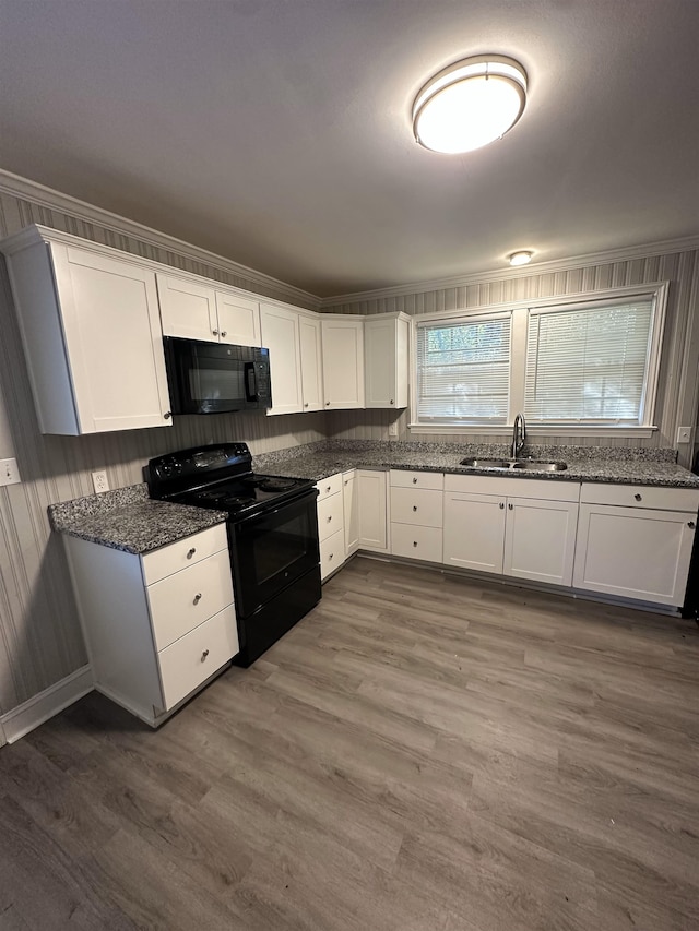 kitchen with black appliances, white cabinetry, and dark hardwood / wood-style floors