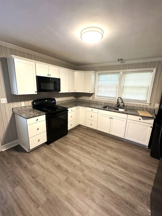 kitchen with black appliances, wood-type flooring, white cabinetry, sink, and ornamental molding