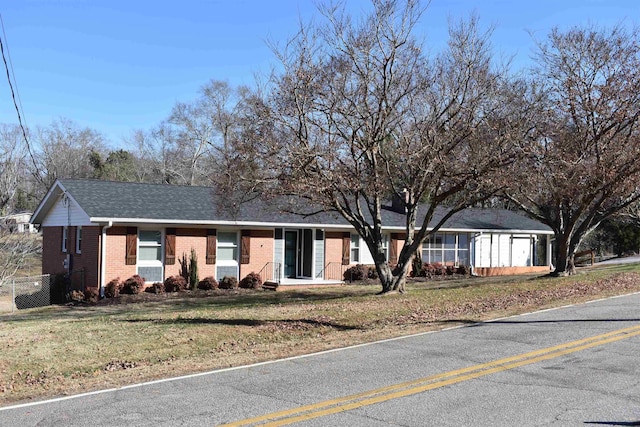 ranch-style house featuring a front lawn