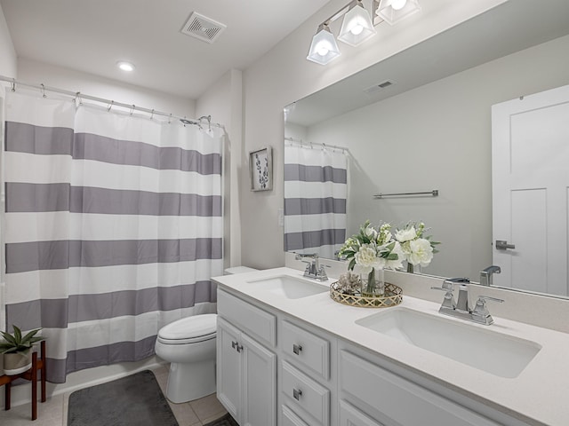 bathroom with vanity, toilet, walk in shower, and tile patterned floors