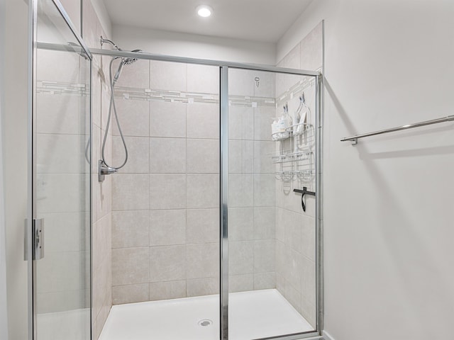 bathroom with a shower with shower door