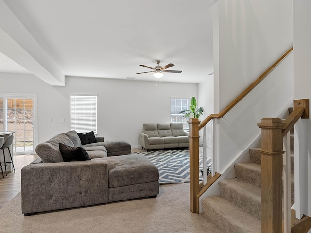 living room featuring light colored carpet and ceiling fan