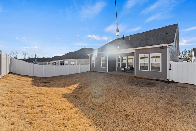 rear view of property with a patio area and a lawn