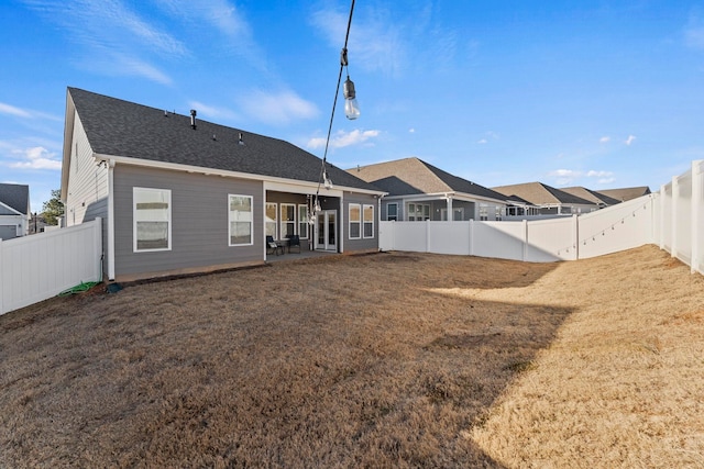 back of house featuring a yard and a patio