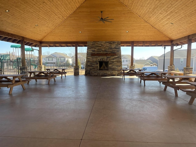 view of patio with a gazebo and an outdoor stone fireplace