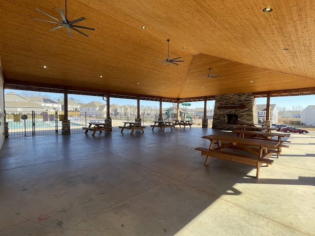 view of patio / terrace featuring ceiling fan, a gazebo, and an outdoor stone fireplace