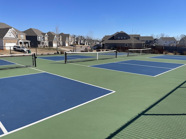 view of tennis court with basketball hoop