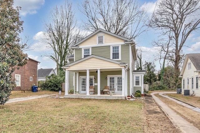 view of front of property featuring covered porch, a front yard, cooling unit, and french doors