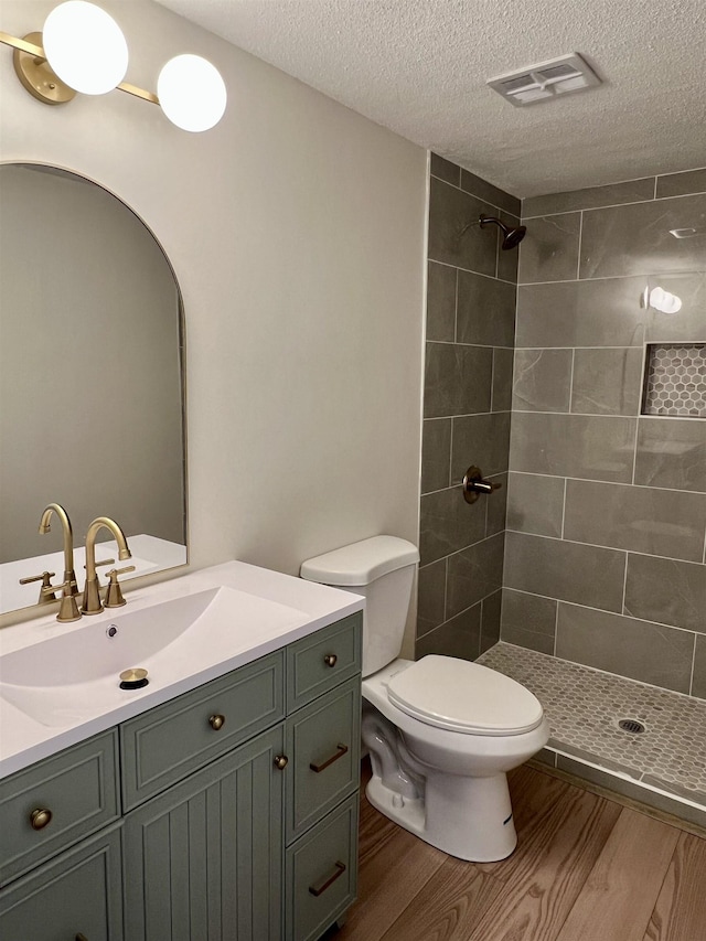 115 Fernbrook Cir, Spartanburg, SC 29307 - full bathroom featuring visible vents, toilet, a tile shower, vanity, and wood finished floors