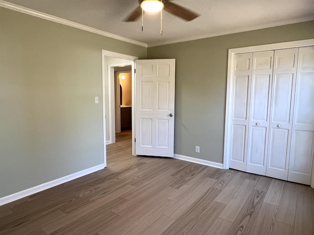 115 Fernbrook Cir, Spartanburg, SC 29307 - unfurnished bedroom with crown molding, a closet, baseboards, and wood finished floors