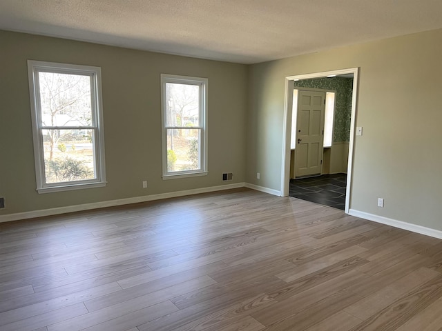 115 Fernbrook Cir, Spartanburg, SC 29307 - unfurnished room featuring a healthy amount of sunlight, baseboards, visible vents, and wood finished floors
