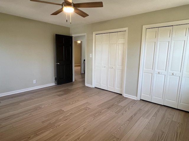 115 Fernbrook Cir, Spartanburg, SC 29307 - unfurnished bedroom featuring a ceiling fan, light wood-style flooring, baseboards, and multiple closets
