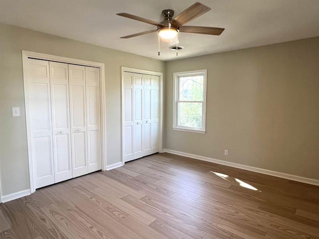 115 Fernbrook Cir, Spartanburg, SC 29307 - unfurnished bedroom featuring ceiling fan, baseboards, two closets, and wood finished floors