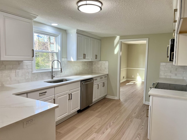 115 Fernbrook Cir, Spartanburg, SC 29307 - kitchen with stainless steel appliances, backsplash, white cabinetry, a sink, and light wood-type flooring