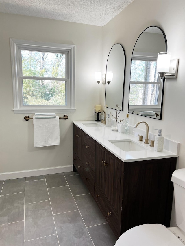 115 Fernbrook Cir, Spartanburg, SC 29307 - full bathroom featuring a textured ceiling, tile patterned flooring, a sink, and toilet