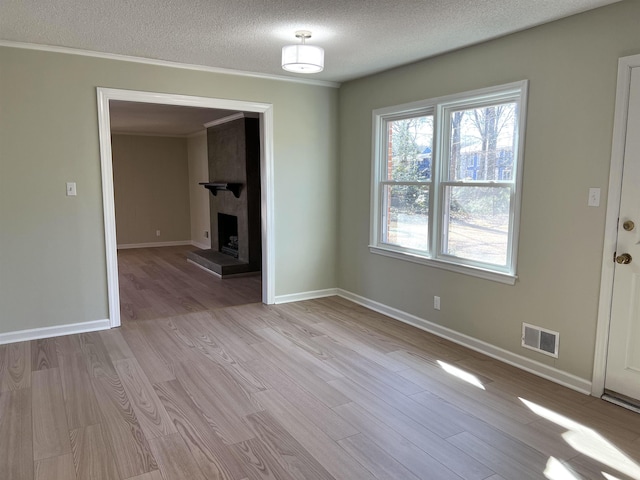 115 Fernbrook Cir, Spartanburg, SC 29307 - unfurnished dining area featuring a textured ceiling, a large fireplace, wood finished floors, visible vents, and baseboards