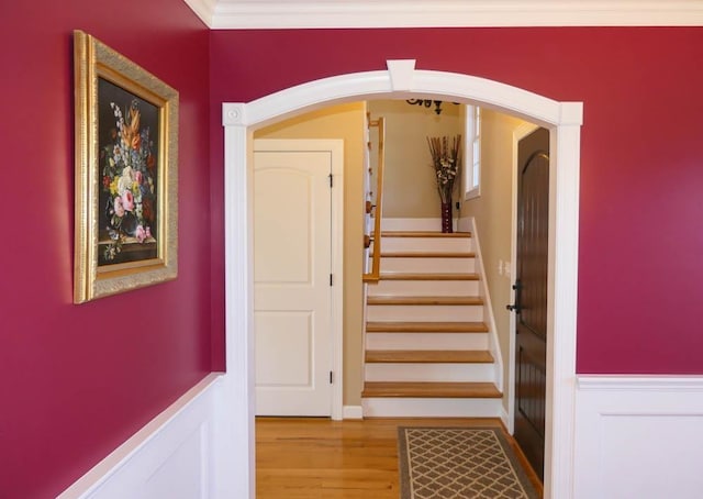 staircase featuring hardwood / wood-style flooring and ornamental molding