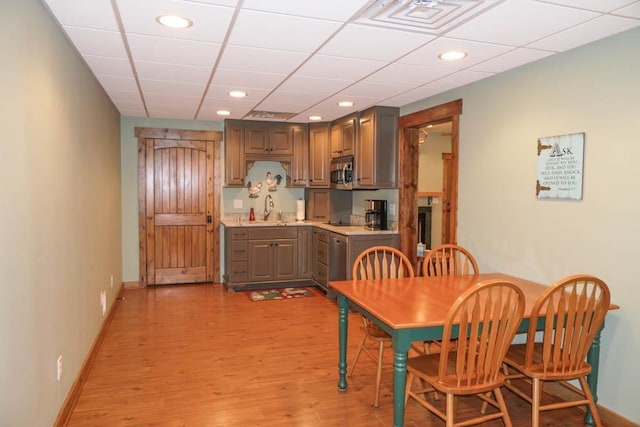 dining room featuring light wood-type flooring and sink