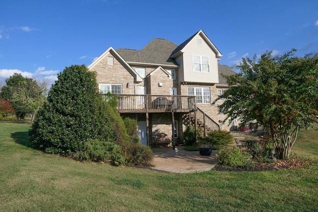 back of house featuring a wooden deck, a patio area, and a yard