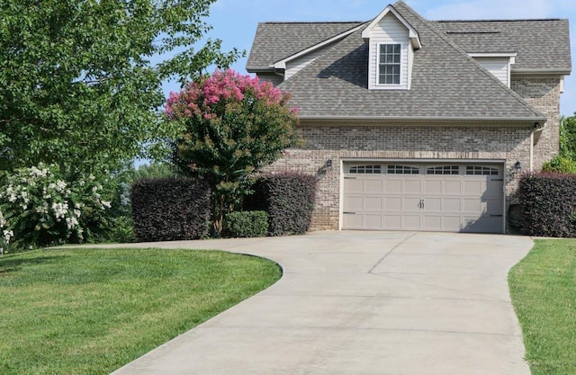 view of front of house with a front yard and a garage