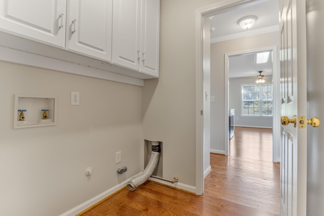 laundry area with cabinets, hookup for a gas dryer, ornamental molding, hookup for a washing machine, and light hardwood / wood-style flooring