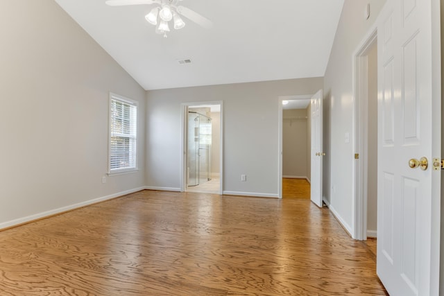 unfurnished room with light wood-type flooring, ceiling fan, and lofted ceiling