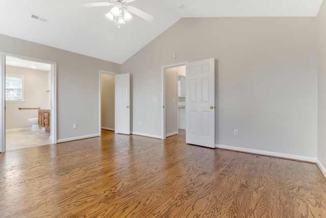 empty room with light wood-type flooring, ceiling fan, and high vaulted ceiling