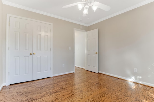 unfurnished bedroom with a closet, ceiling fan, light hardwood / wood-style flooring, and crown molding