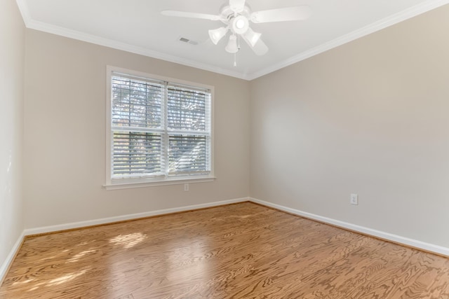 empty room with wood-type flooring, ceiling fan, and ornamental molding