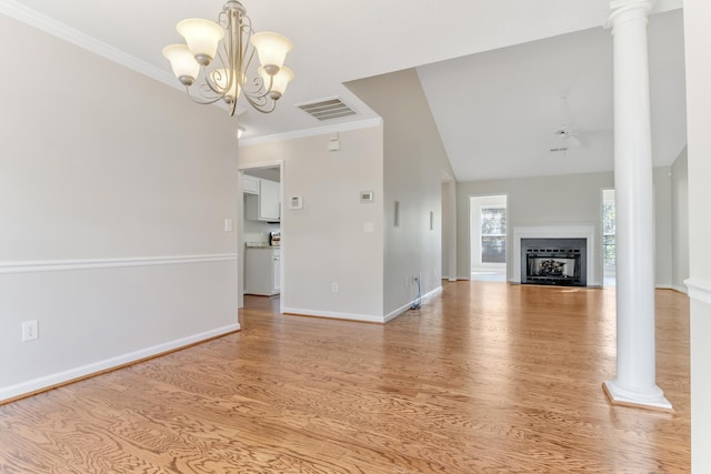 unfurnished living room with crown molding, ornate columns, a chandelier, and light wood-type flooring