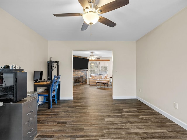 office area featuring a fireplace and dark hardwood / wood-style floors