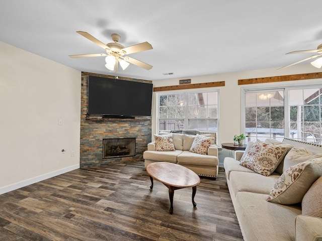 living room featuring a fireplace, dark hardwood / wood-style floors, and ceiling fan