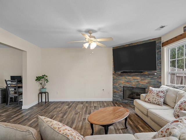 living room with ceiling fan, dark hardwood / wood-style floors, and a fireplace