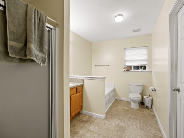 bathroom with vanity, a bathtub, and toilet