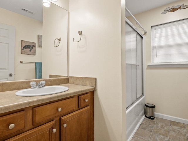 bathroom featuring enclosed tub / shower combo and vanity