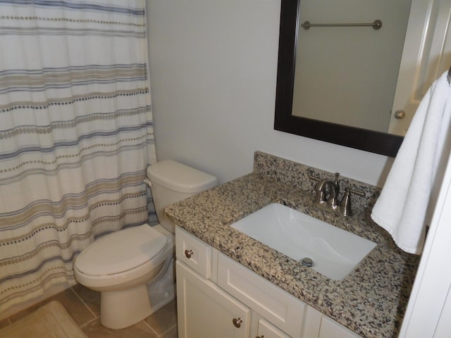 bathroom with toilet, tile patterned flooring, and vanity