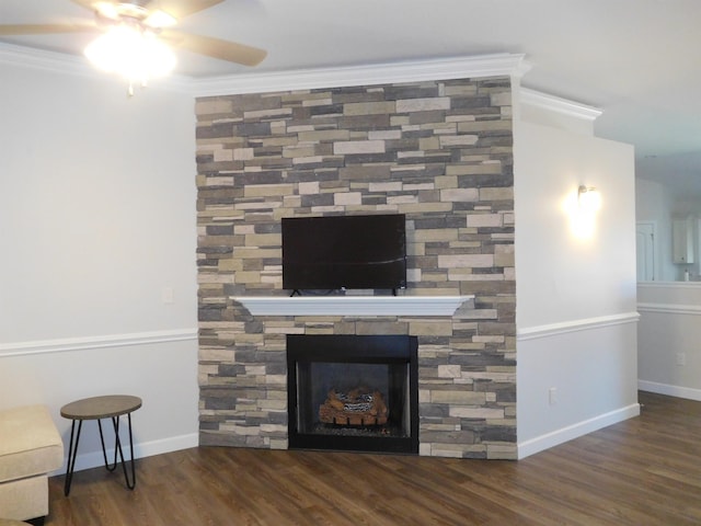 room details featuring a fireplace, wood-type flooring, ceiling fan, and ornamental molding