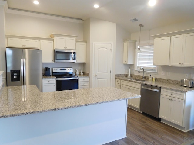 kitchen with sink, decorative light fixtures, white cabinetry, and stainless steel appliances