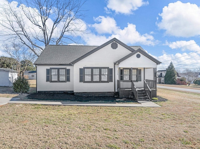 view of front of home with covered porch and a front yard