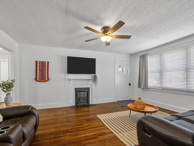 living room featuring ceiling fan and dark hardwood / wood-style flooring