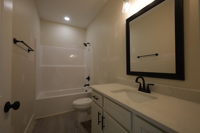 full bathroom featuring wood-type flooring, toilet, shower / bathing tub combination, and vanity