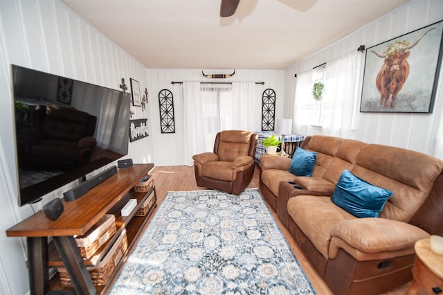 living room featuring hardwood / wood-style flooring, a wealth of natural light, and ceiling fan