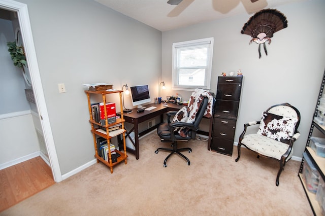 carpeted office space with ceiling fan