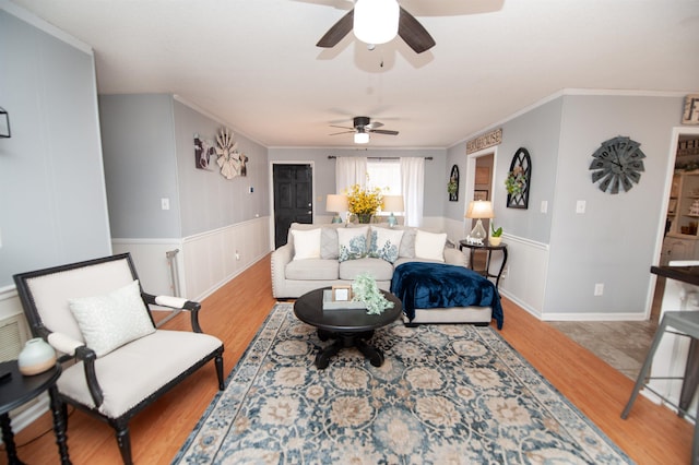 living room with light hardwood / wood-style floors and crown molding