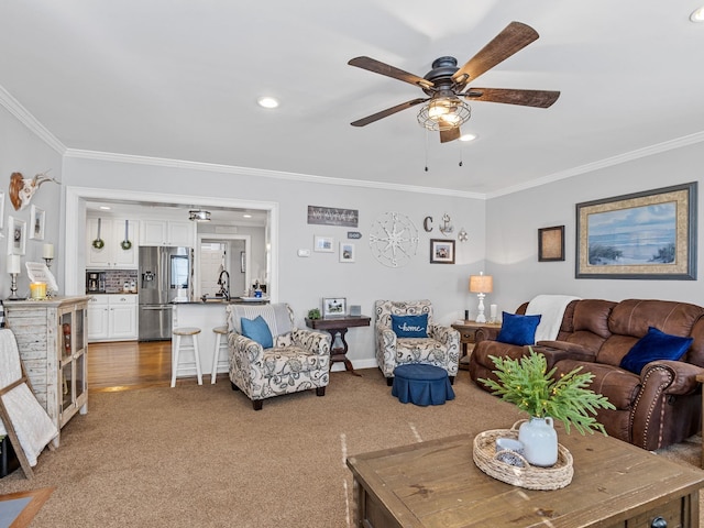 carpeted living room featuring crown molding and ceiling fan