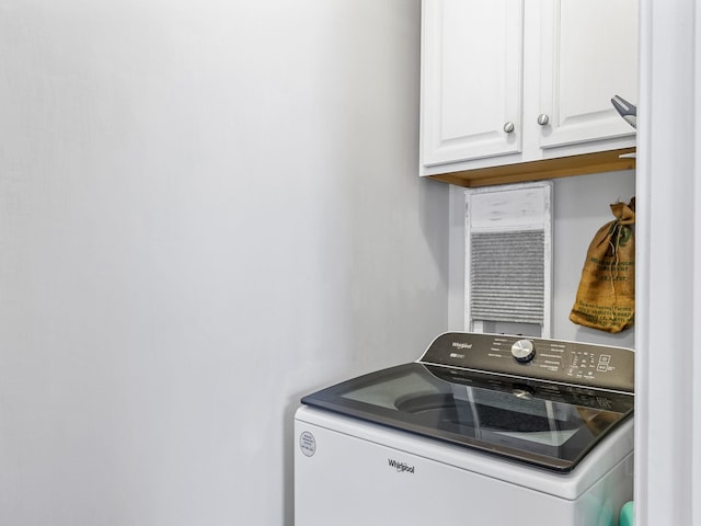 washroom featuring cabinets and washer / dryer